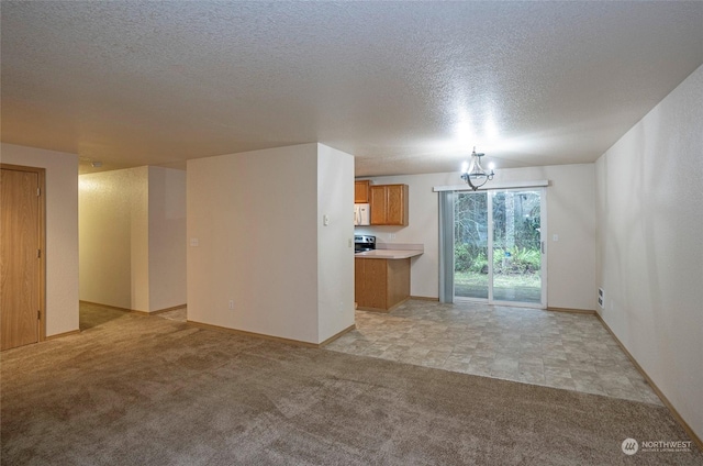 unfurnished living room with light carpet and an inviting chandelier