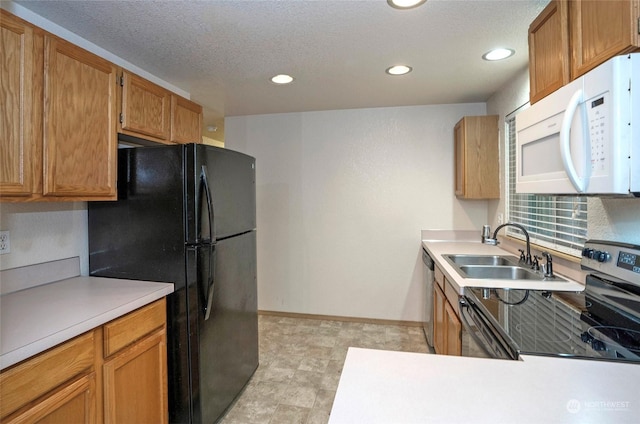 kitchen featuring a textured ceiling, sink, and stainless steel appliances