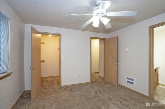 unfurnished bedroom with ceiling fan and light carpet