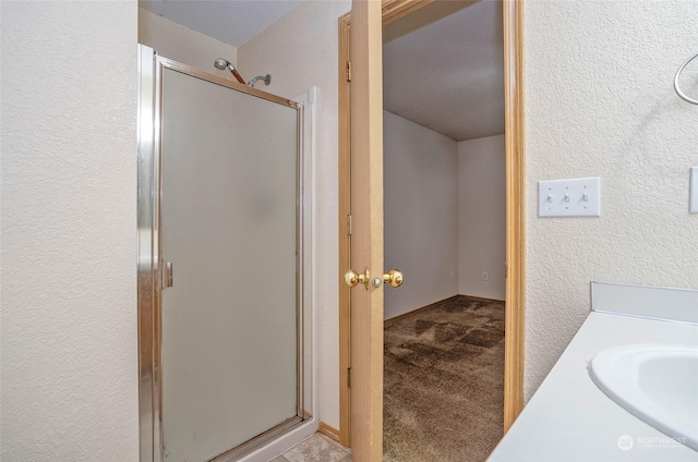 bathroom featuring vanity and an enclosed shower