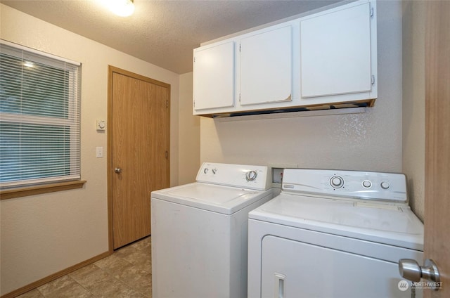 clothes washing area featuring cabinets, a textured ceiling, and independent washer and dryer