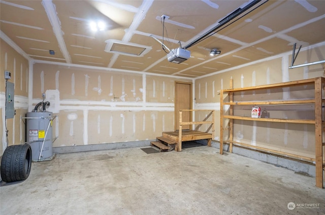 garage featuring electric panel, water heater, and a garage door opener