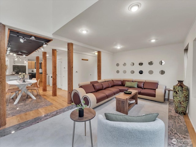 living room with light hardwood / wood-style flooring and ornamental molding