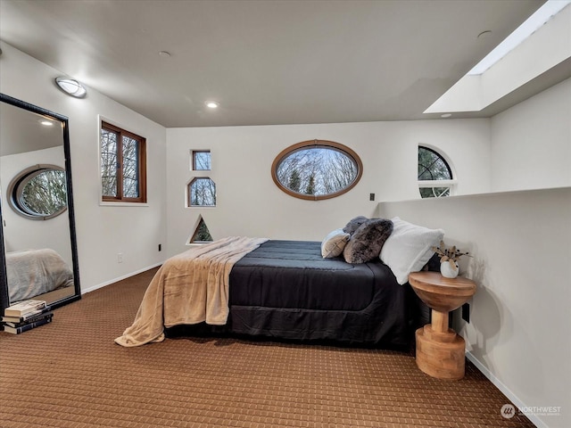 carpeted bedroom featuring a skylight