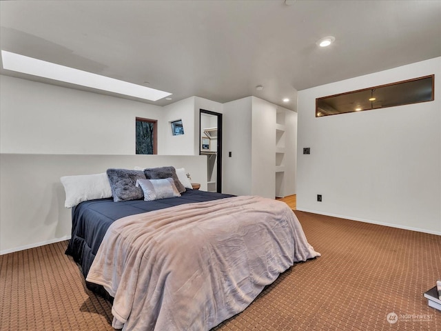 bedroom featuring carpet floors and a skylight