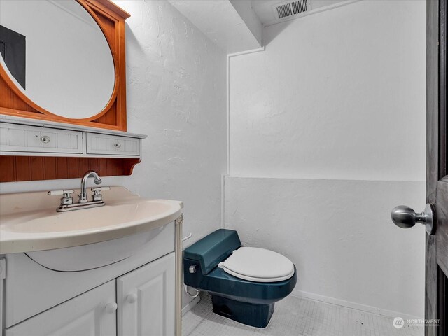 bathroom with tile patterned floors, vanity, and toilet