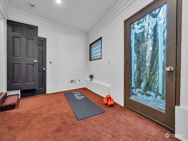 workout room with ornamental molding