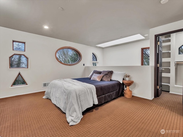 carpeted bedroom with a skylight