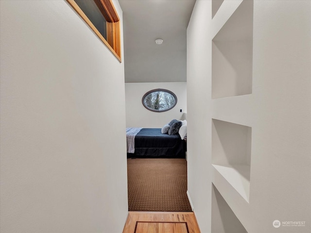 hallway with wood-type flooring