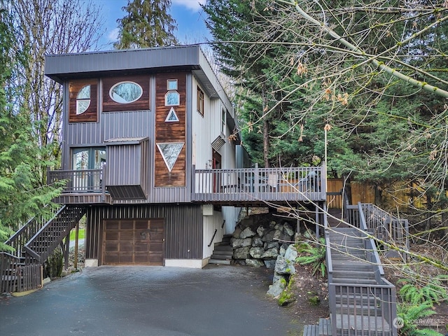 view of front facade with a wooden deck and a garage