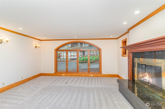 unfurnished living room with a tile fireplace, light carpet, and ornamental molding