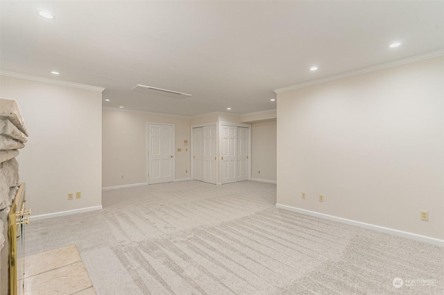 unfurnished living room with a stone fireplace, ornamental molding, and light carpet