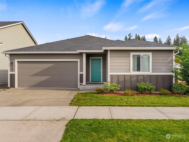 view of front facade with a garage and a front lawn