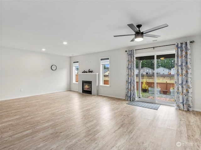 unfurnished living room with light hardwood / wood-style floors and ceiling fan