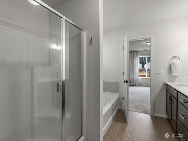 bathroom featuring vanity and plus walk in shower