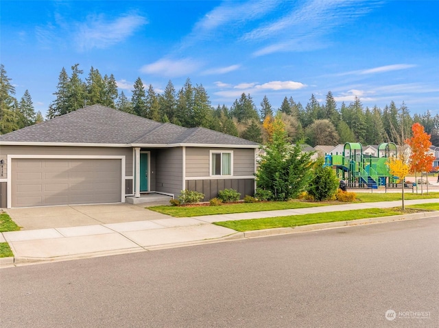 view of front facade with a garage and a playground