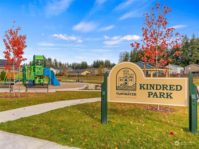 community sign featuring a lawn