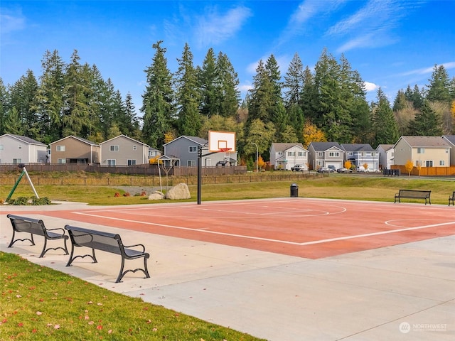 view of sport court featuring a yard