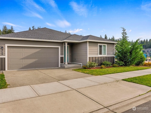 single story home featuring a front yard and a garage