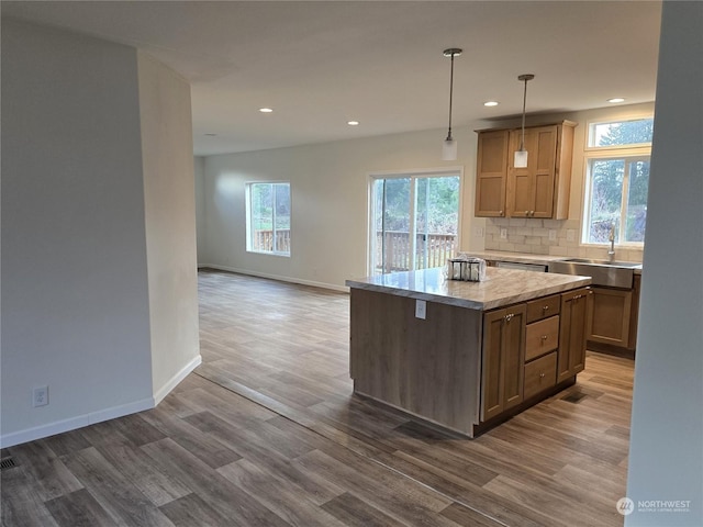 53 Newton Rd, Forks, WA 98331 - kitchen featuring wood finished floors, light countertops, recessed lighting, a kitchen island, and healthy amount of natural light