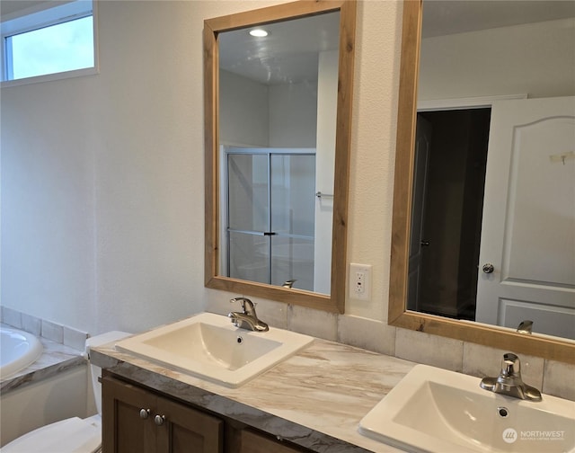 full bathroom with shower with separate bathtub, vanity, and toilet