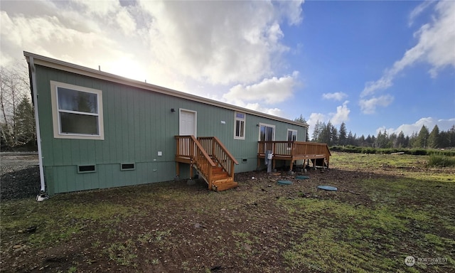53 Newton Rd, Forks, WA 98331 - back of property with crawl space and a wooden deck