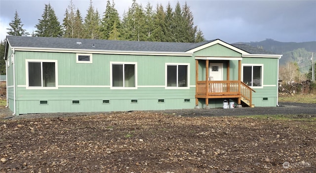 back of house with a mountain view