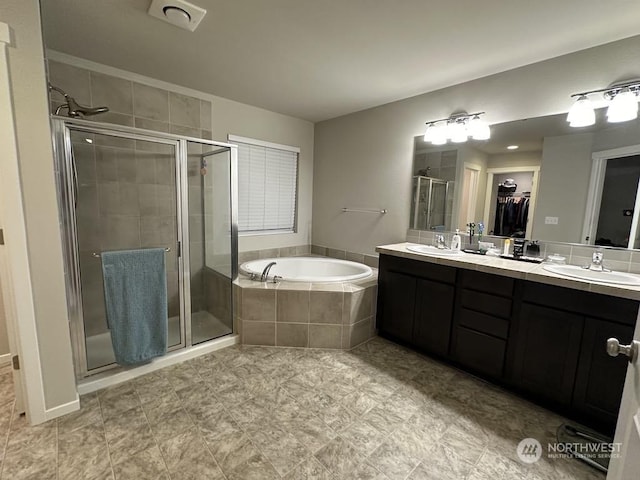 bathroom with vanity and independent shower and bath