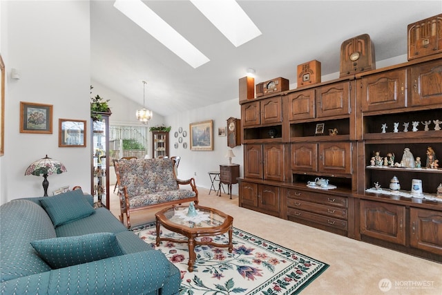 carpeted living area with vaulted ceiling with skylight and a chandelier
