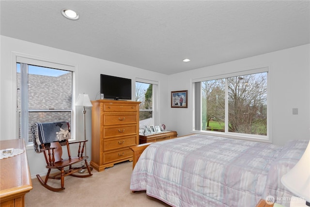 bedroom with recessed lighting, a textured ceiling, and light colored carpet