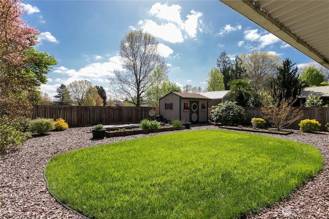 view of yard featuring a storage unit, a fenced backyard, and an outbuilding