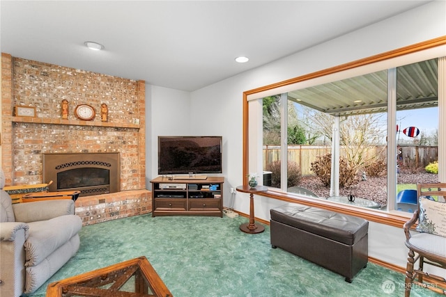 living area with a brick fireplace, recessed lighting, carpet flooring, and baseboards