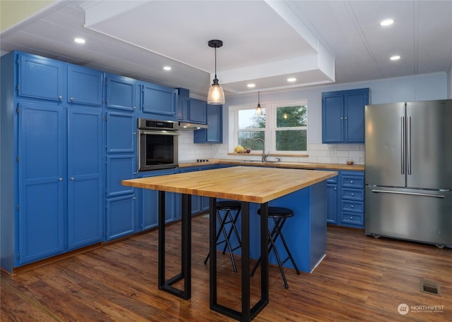 4495 Sequim Dungeness Way, Sequim, WA 98382 - kitchen featuring appliances with stainless steel finishes, butcher block counters, blue cabinetry, a breakfast bar, and decorative backsplash
