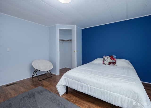 bedroom featuring dark wood-type flooring and a closet