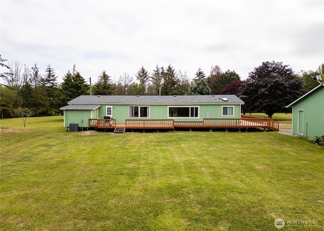 4495 Sequim Dungeness Way, Sequim, WA 98382 - rear view of house featuring a wooden deck and a lawn