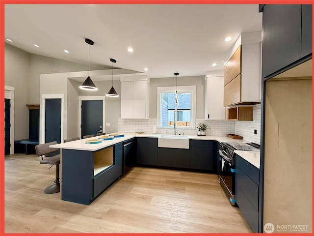 109 Sunrise Ave SE, Ocean Shores, WA 98569 - kitchen featuring a sink, black appliances, a peninsula, white cabinetry, and backsplash