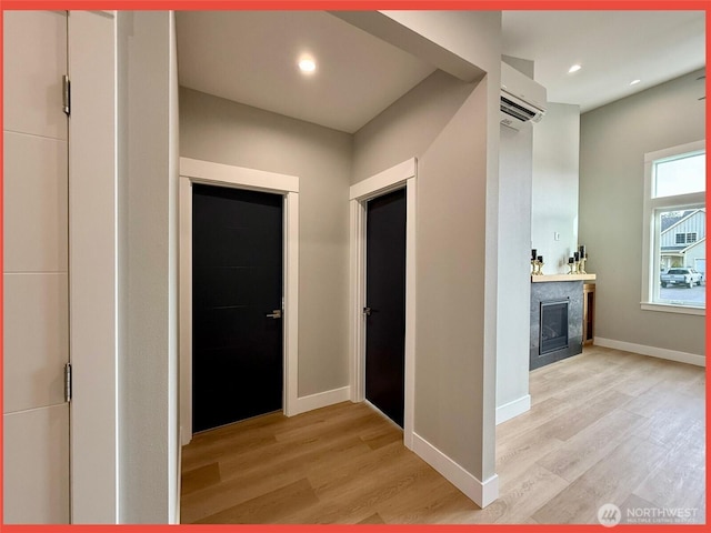 109 Sunrise Ave SE, Ocean Shores, WA 98569 - hallway with light wood-style floors, a wall unit AC, baseboards, and recessed lighting