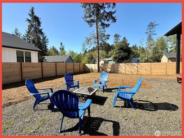 109 Sunrise Ave SE, Ocean Shores, WA 98569 - fenced backyard featuring an outdoor fire pit