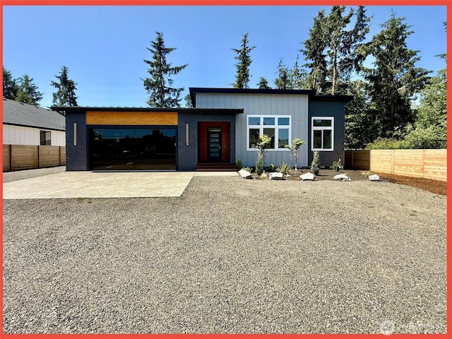 109 Sunrise Ave SE, Ocean Shores, WA 98569 - modern home featuring driveway, board and batten siding, and an attached garage