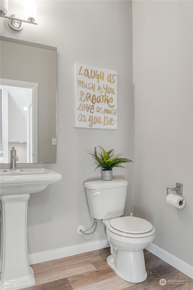 bathroom featuring toilet and hardwood / wood-style flooring