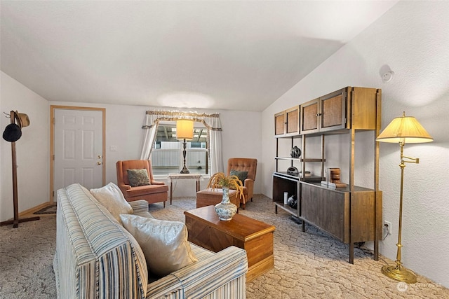 carpeted living room with lofted ceiling