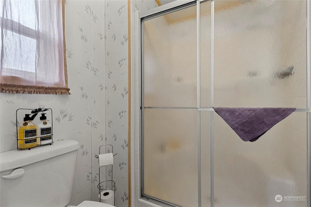 bathroom with toilet and walk in shower