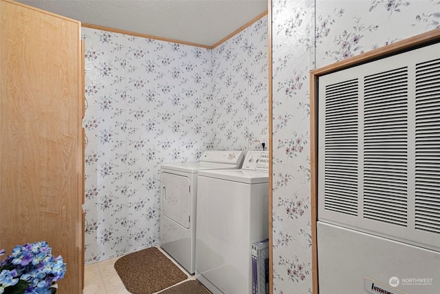 laundry area featuring independent washer and dryer, a textured ceiling, and crown molding