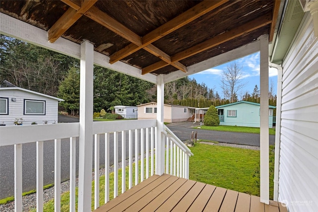 wooden deck featuring a lawn