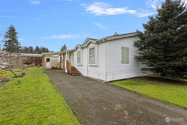 view of side of home with a yard