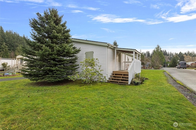 view of side of property with a yard