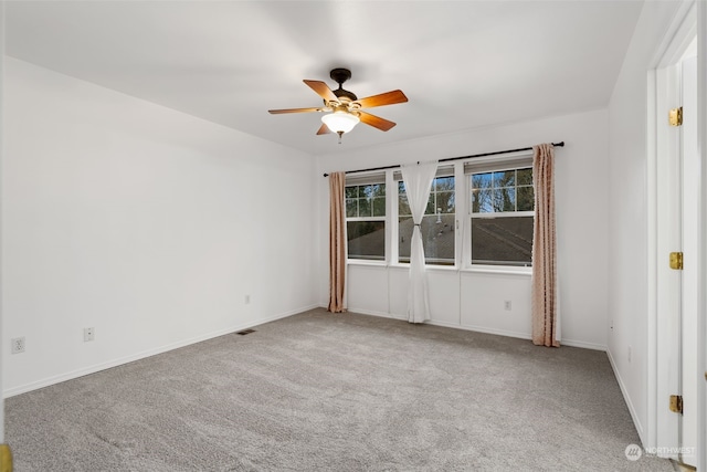 carpeted spare room with ceiling fan