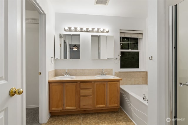 bathroom featuring a washtub and vanity