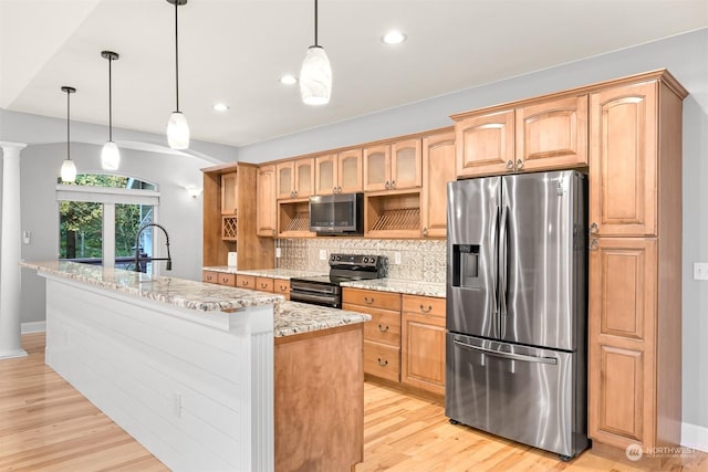 kitchen with light stone countertops, stainless steel appliances, backsplash, pendant lighting, and a kitchen island with sink