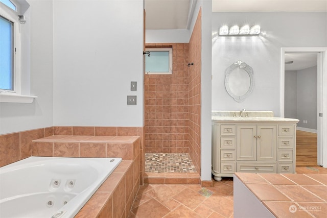 bathroom featuring vanity and independent shower and bath